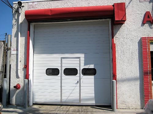 Sectional Door with Pass-Through Door; White Sectional Door with Pass-Through Door; view from the outside-1